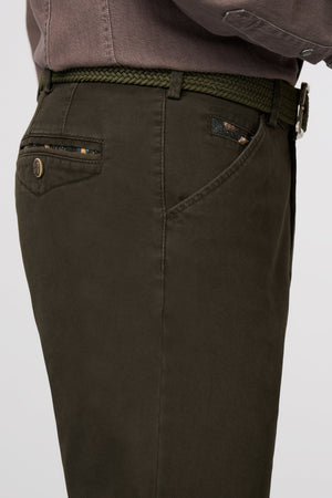 Dark green pants with a belt on a light gray background